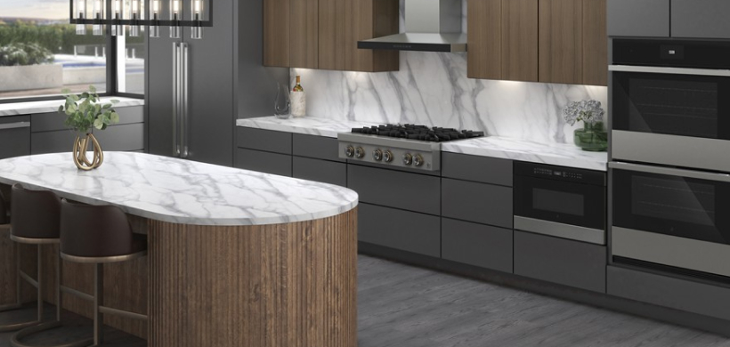 A modern kitchen with black marble counter and backsplash.
